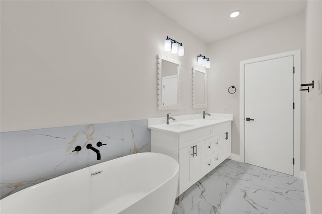 bathroom featuring vanity and a tub