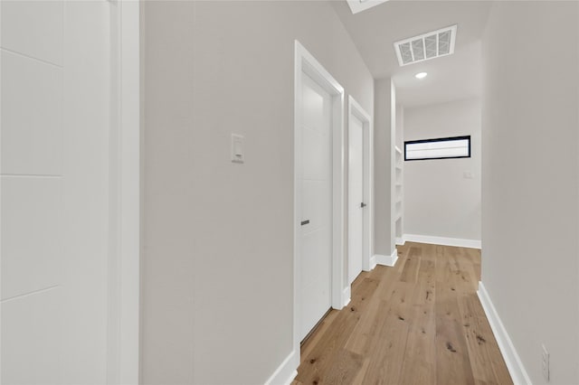 corridor with light hardwood / wood-style floors