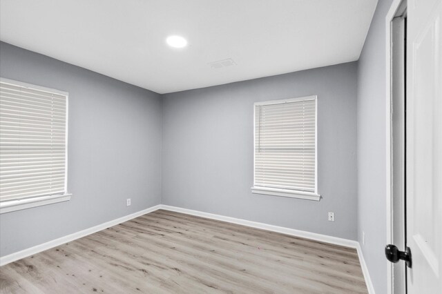 unfurnished room featuring light hardwood / wood-style floors