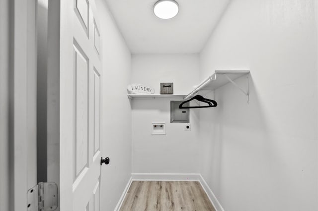 laundry room with baseboards, electric panel, laundry area, hookup for a washing machine, and light wood-style floors