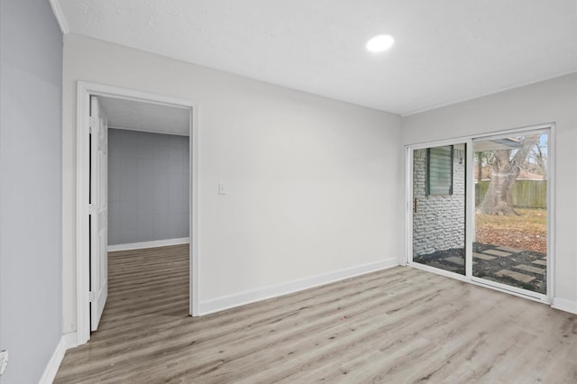 unfurnished room with baseboards and wood finished floors