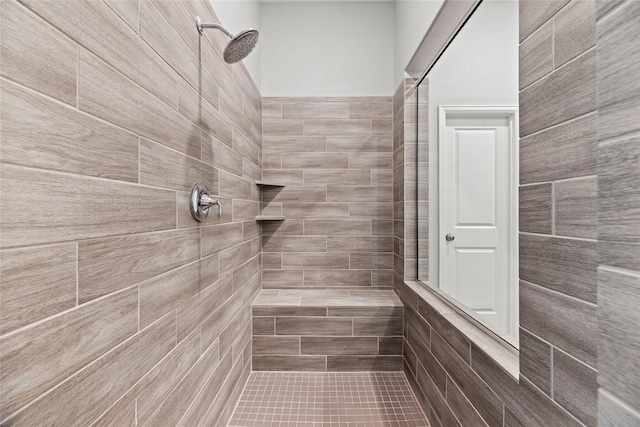 bathroom with a tile shower