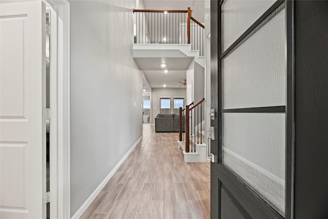 interior space with light hardwood / wood-style flooring and a high ceiling