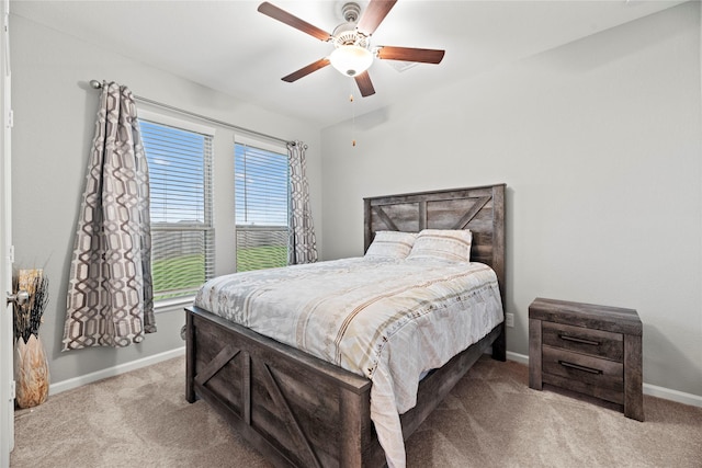 bedroom with ceiling fan and light carpet