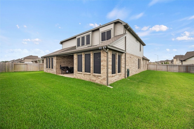 back of property featuring a patio area and a lawn