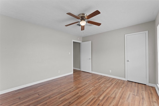 spare room with ceiling fan and light hardwood / wood-style flooring