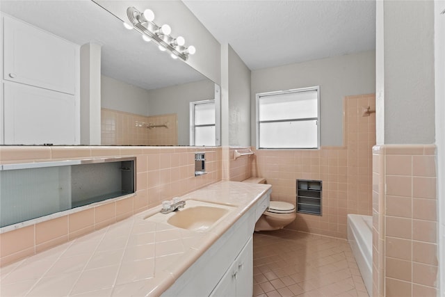 full bathroom featuring tile patterned flooring, tile walls, vanity, a textured ceiling, and toilet