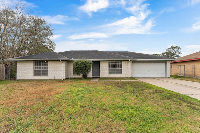 single story home featuring a garage and a front yard