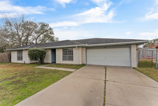 ranch-style house featuring a garage and a front lawn