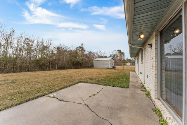 view of yard with a storage shed and a patio area