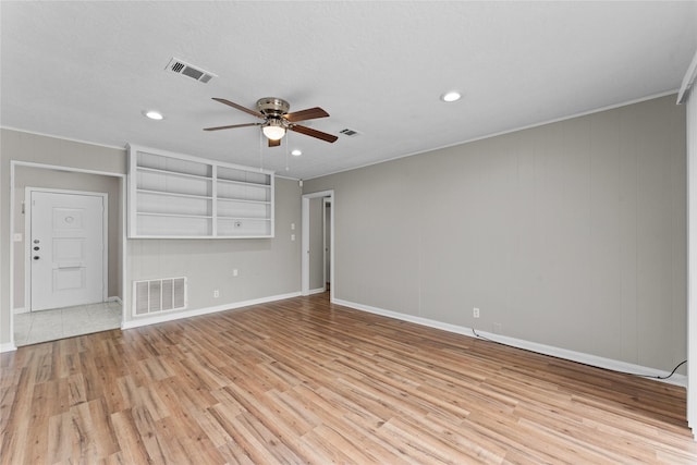 unfurnished living room featuring crown molding, ceiling fan, and light hardwood / wood-style flooring