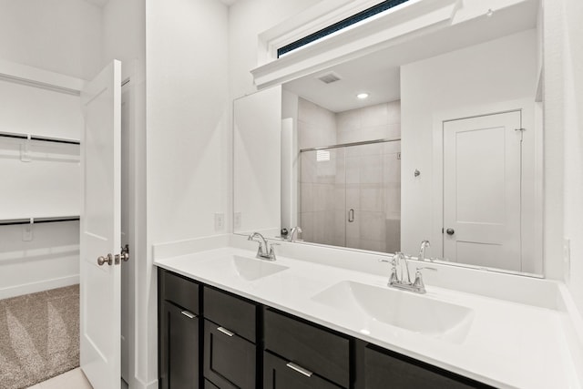 bathroom with vanity and a shower with shower door