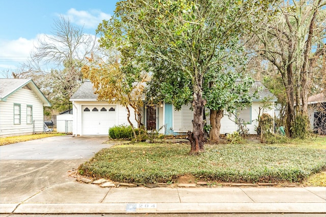 view of property hidden behind natural elements featuring a garage