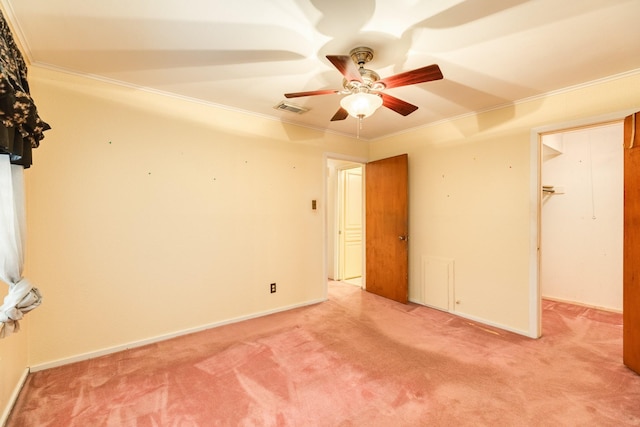 carpeted spare room featuring ornamental molding and ceiling fan