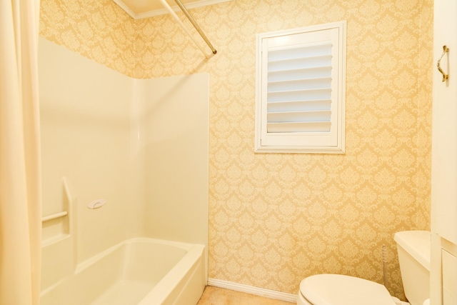 bathroom featuring shower / tub combination and toilet