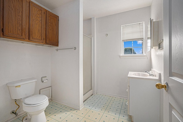 bathroom featuring vanity, toilet, and an enclosed shower