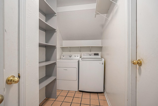 washroom with independent washer and dryer and light tile patterned floors