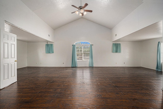 unfurnished living room with dark wood-type flooring, high vaulted ceiling, and ceiling fan