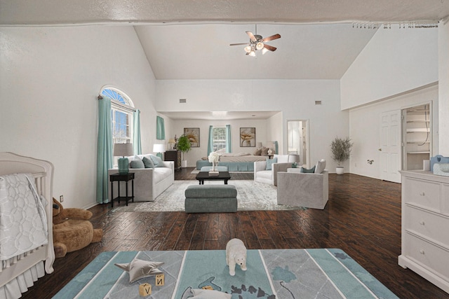 living room with hardwood / wood-style floors, high vaulted ceiling, and ceiling fan