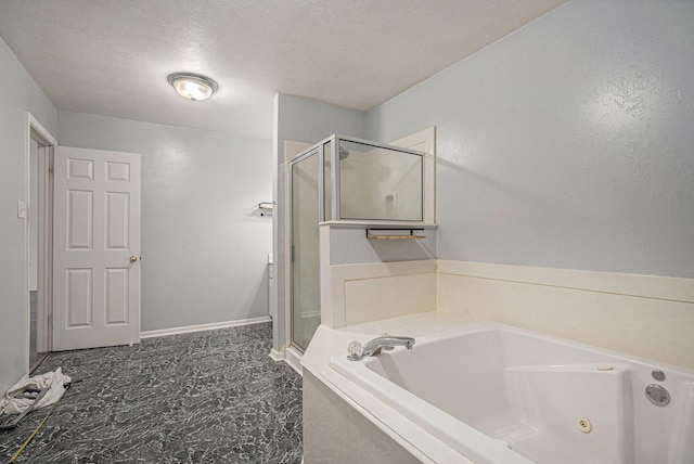 bathroom with separate shower and tub and a textured ceiling