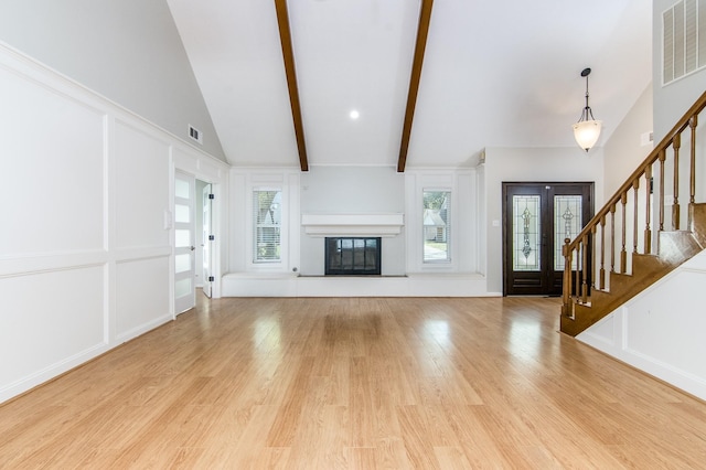 unfurnished living room with beamed ceiling, high vaulted ceiling, and light hardwood / wood-style flooring