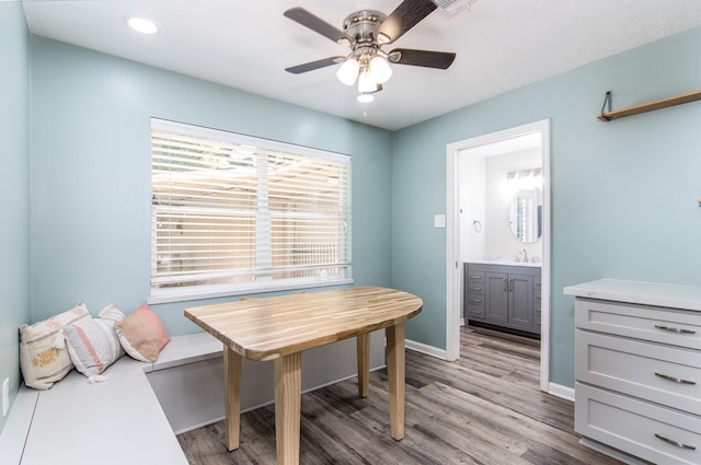 dining space with ceiling fan, sink, and hardwood / wood-style floors