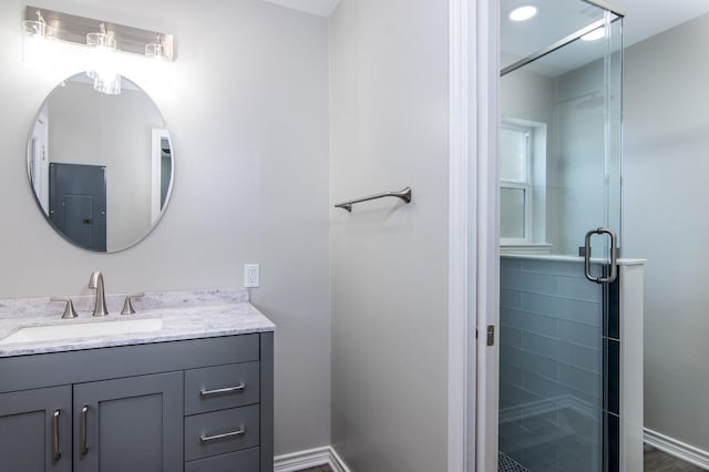 bathroom with walk in shower and vanity