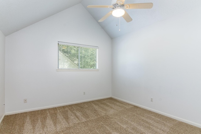 spare room featuring vaulted ceiling, ceiling fan, and carpet floors