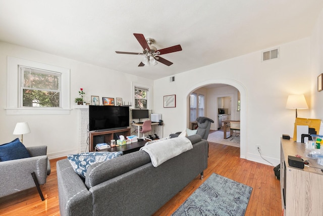 living room with hardwood / wood-style flooring, ceiling fan, and a healthy amount of sunlight