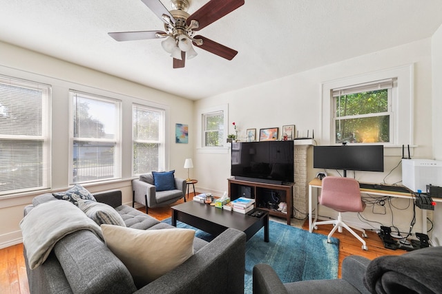 living room with hardwood / wood-style flooring, a wealth of natural light, and ceiling fan