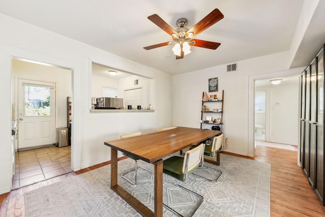 dining room with ceiling fan and light wood-type flooring