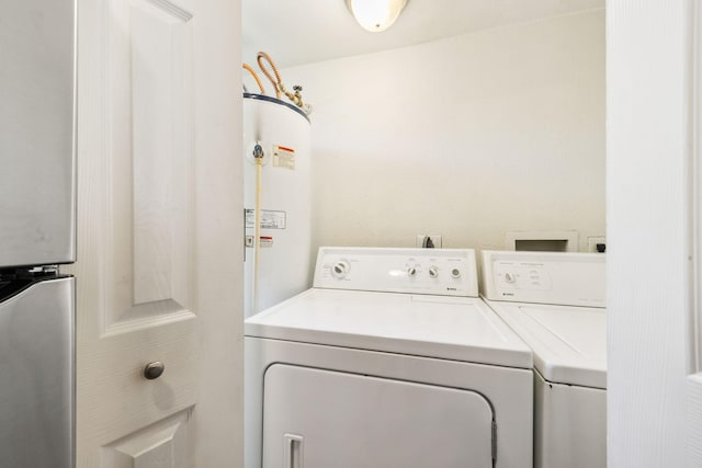 laundry room featuring gas water heater and washing machine and clothes dryer