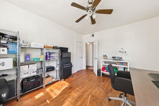 office with hardwood / wood-style flooring and ceiling fan