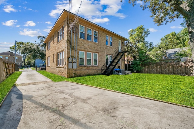 back of property featuring a lawn