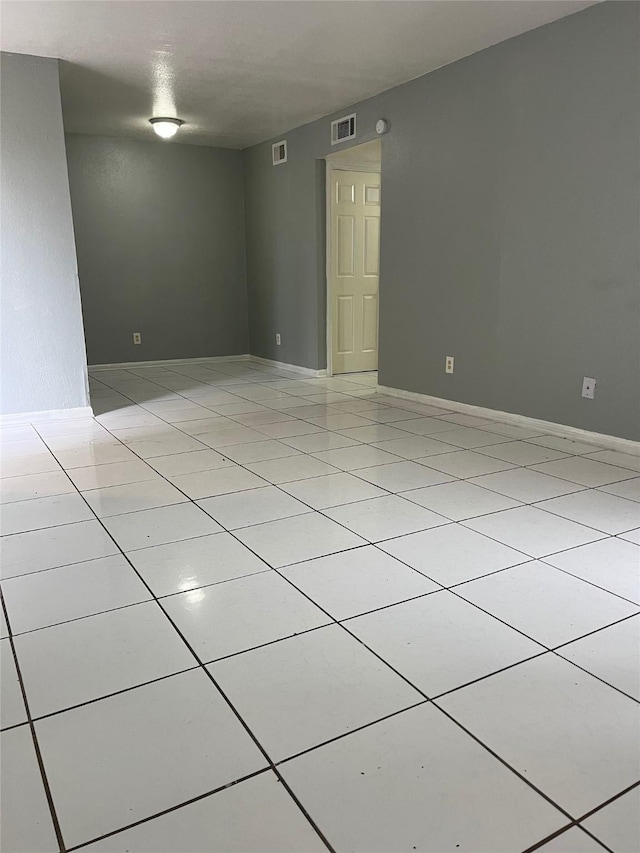 unfurnished room featuring light tile patterned flooring