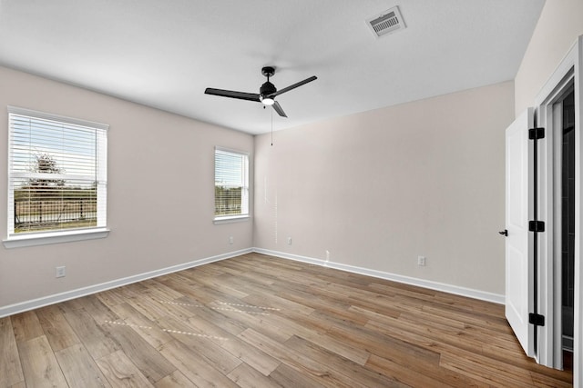 empty room featuring ceiling fan and light hardwood / wood-style flooring