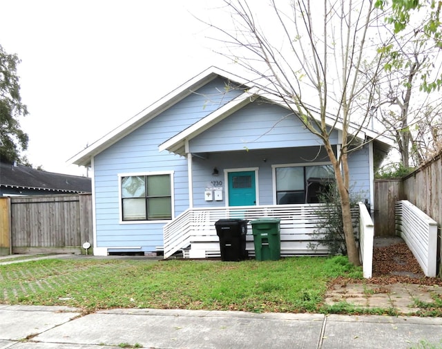 bungalow-style house with a front lawn