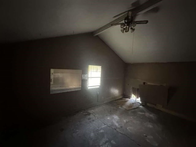 empty room with lofted ceiling with beams