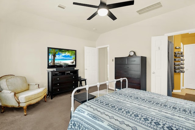 carpeted bedroom with ceiling fan and vaulted ceiling