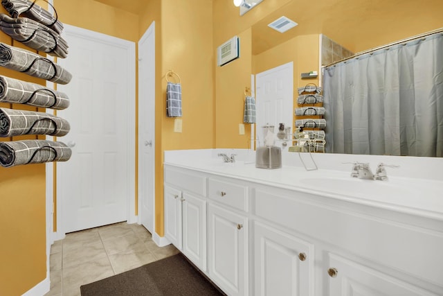 bathroom featuring tile patterned flooring, vanity, and curtained shower