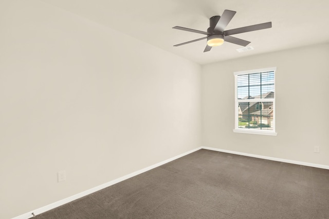 unfurnished room with ceiling fan and dark colored carpet