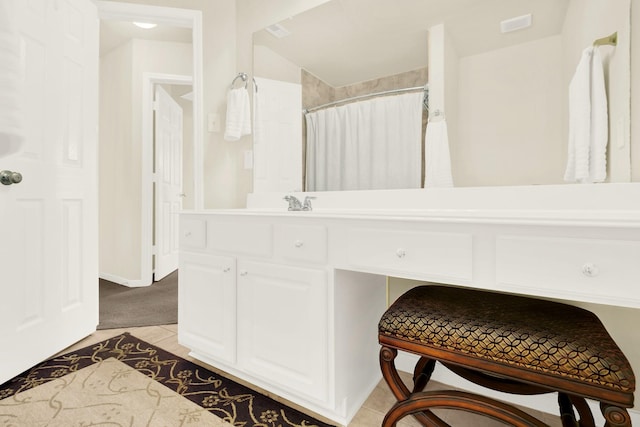 bathroom with tile patterned flooring and vanity