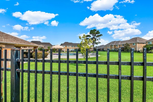 view of gate with a yard