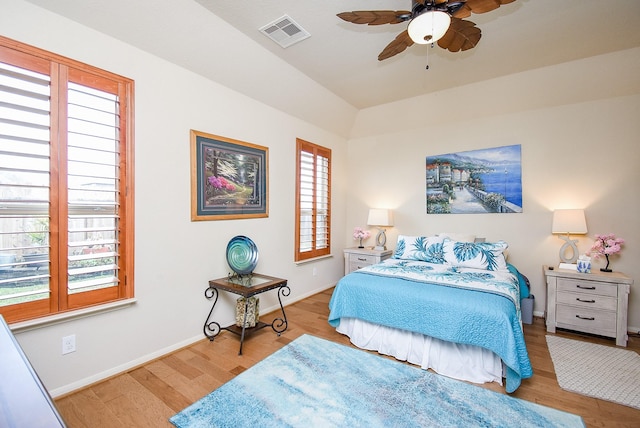 bedroom with multiple windows, light hardwood / wood-style floors, and ceiling fan