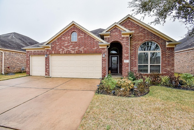 view of property featuring a garage and a front yard