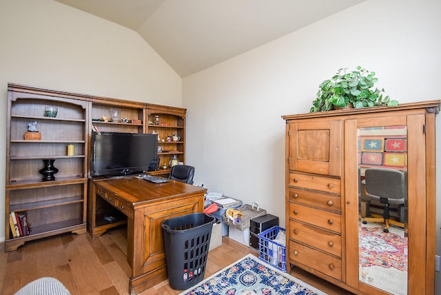 office space featuring lofted ceiling and light hardwood / wood-style flooring