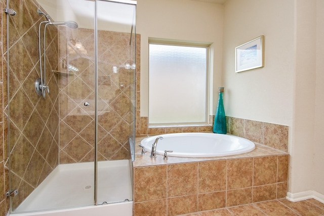 bathroom featuring tile patterned floors and shower with separate bathtub