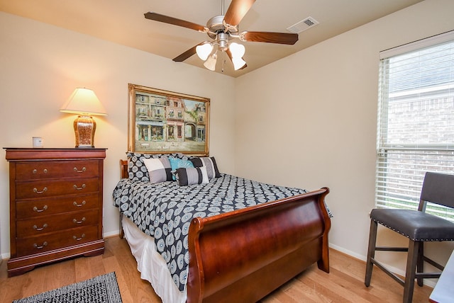 bedroom with light hardwood / wood-style floors and ceiling fan