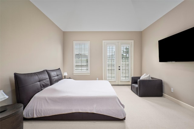 bedroom featuring lofted ceiling, access to exterior, carpet floors, and french doors