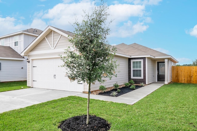 view of front of property with a garage and a front yard